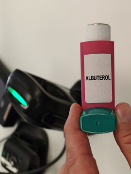 ALBUTEROL beta-2 agonist bronchodilator for obstructive airway disease in a metered dose inhaler with a pharmacy barcode scanner in the background