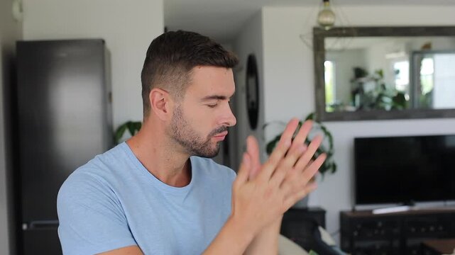 Excited man rubbing hands together in eager anticipation 