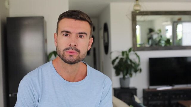 A man looking at the camera listens intently and nods
