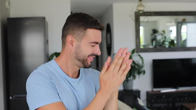 Excited man rubbing hands together in eager anticipation with bright smile