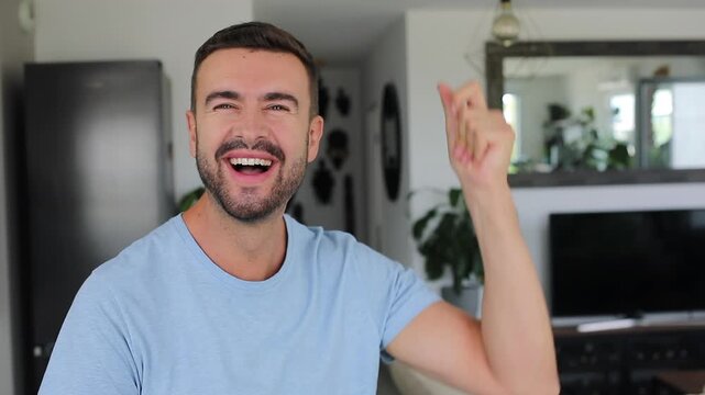 Happy man snapping fingers at camera, signaling something is changing