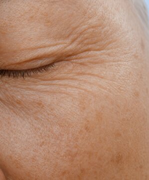Close up of mature woman eye with fine lines and wrinkles