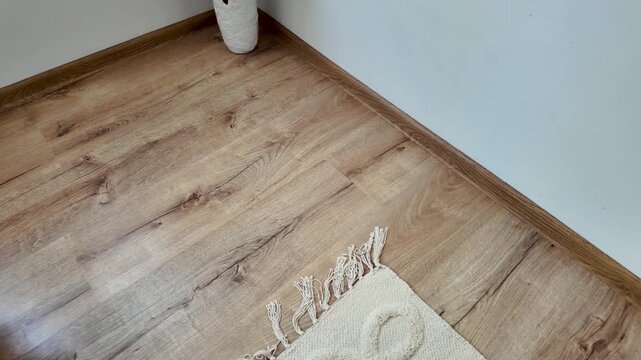 Natural wood laminate parquet floor. Room with laminate in new apartmen. Cozy home interior, modern design
