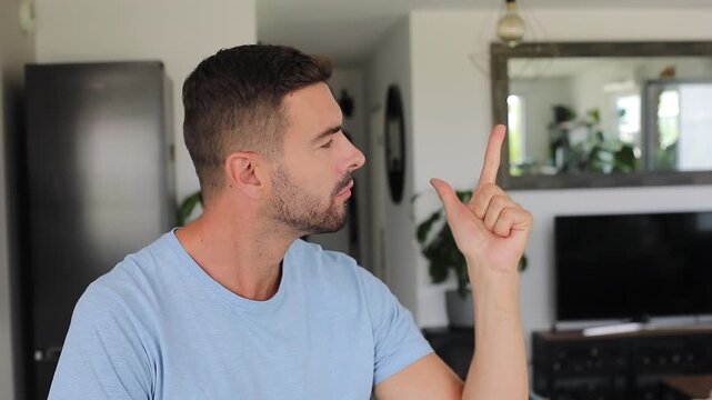 Man counting five fingers toward camera before smiling with joy