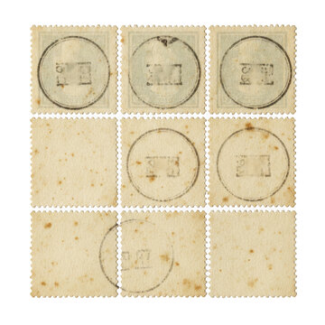 Old vintage postage stamps with ink postmarks on textured paper