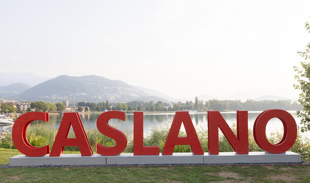 A red sign with the word &lsquo;Caslano&rsquo; written in large letters
