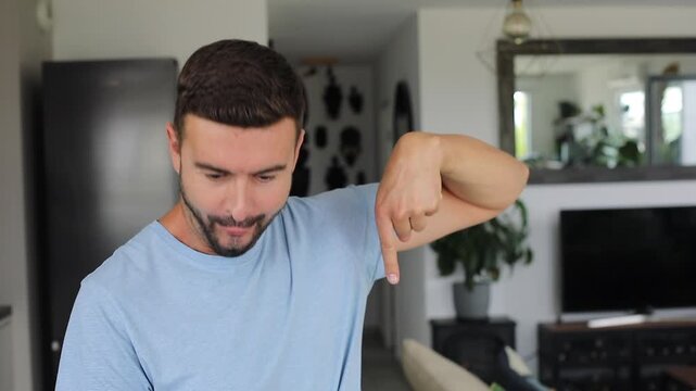 Man pointing down acting surprised
