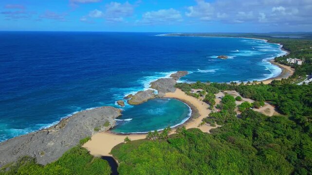An aerial drone perspective showcases the brilliant contrasting blue shades surrounding the natural pool at Mar Chiquita Beach.