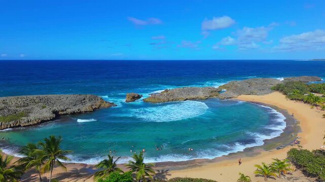 High above the northern coast of Puerto Rico, an aerial shot reveals the dramatic ocean surges at Mar Chiquita Beach.