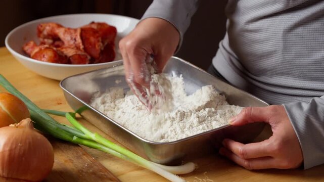 Preparing chicken breading with herbs and spices