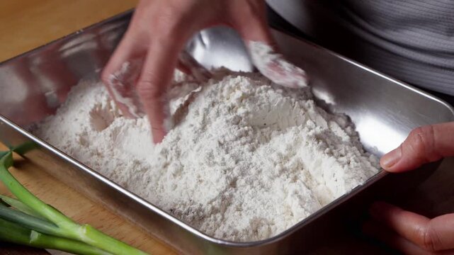 Preparing chicken breading with herbs and spices
