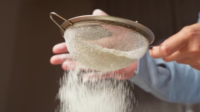 Sifting flour through a fine mesh strainer