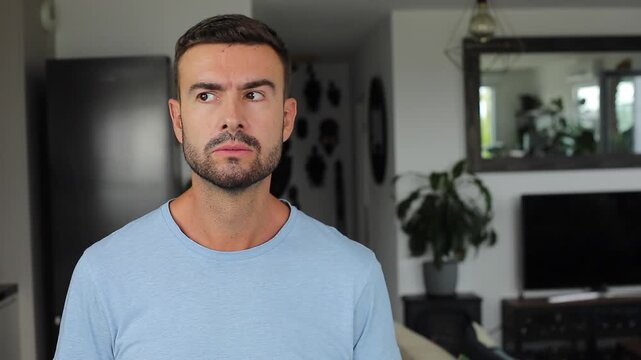 Serious man noticing camera and recording with smartphone in suspicious reaction