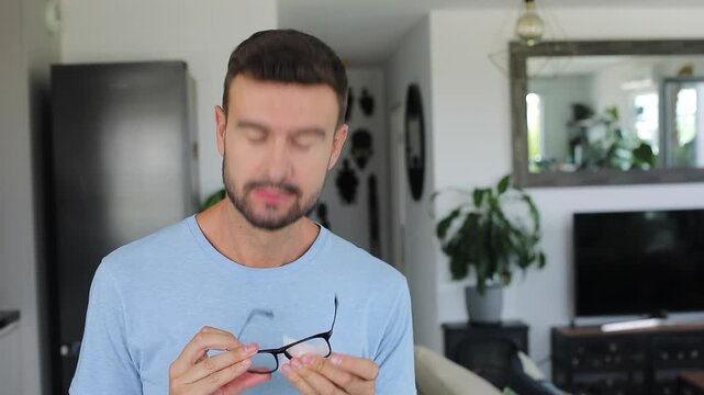 Man carefully cleaning his reading glasses with special wet wipe