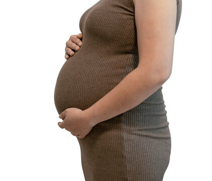Side view of a pregnant belly in a brown knit dress cradled by both hands, isolated on a transparent background.
