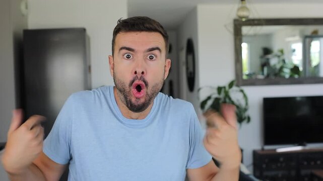 Happy man expressing absolute shock and joy after hearing amazing news