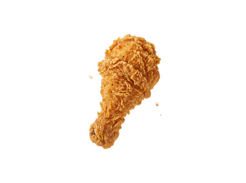 A perfectly golden fried chicken drumstick is captured mid-air, showcasing its crispy texture. The crunchy coating and visible seasoning make it look irresistibly delicious.