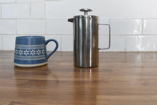 Kitchen Counter with Basil Plant, Wooden Coffee Pots, Cup and Saucer with Copy Space
