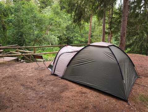 Tourist camping tent pitched at a public campsite surrounded by pine trees near Nommeveski in Lahemaa National Park Estonia.