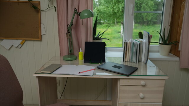 Remote workplace of accountant, bookkeeper. No people. Work place in a kitchen. Working from home. Business report, data entry for company tasks. Laptop, calculator and paperwork. Study, productivity