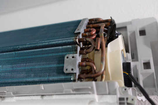 Air conditioner internal evaporator coil. Close up view of cooling system part during maintenance