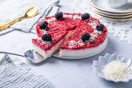 Refreshing no-bake coconut yogurt cake with vibrant berry topping and blackberries