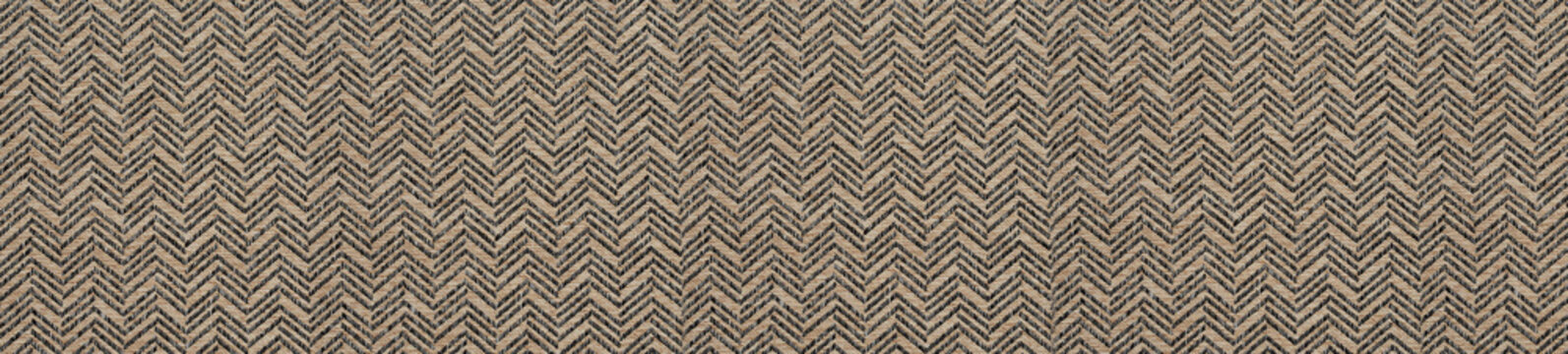 Brown and black herringbone woven fabric texture with intricate zigzag pattern detail