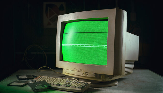 This atmospheric, retro computing scene features a vintage CRT monitor glowing green, a dusty keyboard, and old floppy disks on a table. With nobody present, it evokes nostalgia.