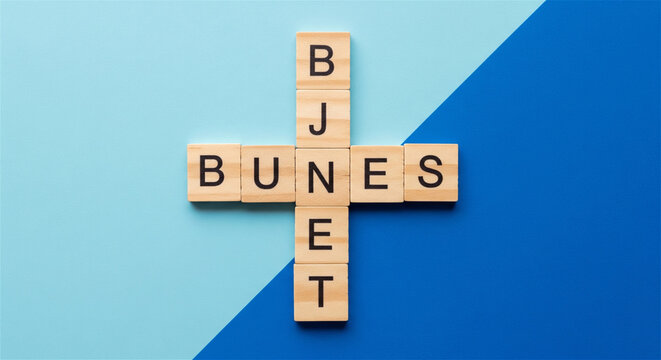 Wooden alphabet blocks spelling the word 'Business' in a crossword puzzle formation.