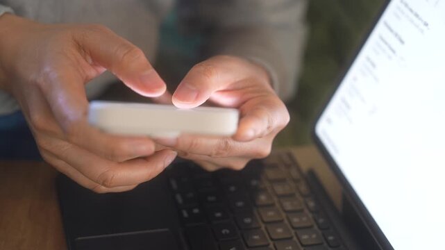 Smartphone And Laptop Technology, Close Up Hands Typing On Mobile Phone Beside Computer, Online Communication, Remote Work, Business Productivity, Connected Workspace And Multi Device Workflow.
