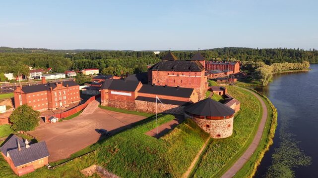 Panoramic drone fly around historical castle H&auml;meen linna in Finland with city and rural forest background 