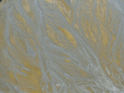 Aerial view of intricate sand and water patterns in a river delta in Poland.