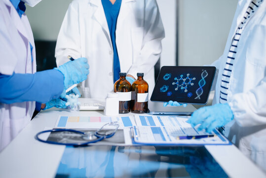 Scientists analyze DNA genetics data using digital technology in a modern medical laboratory, advancing biotechnology, genomics, healthcare research, and precision medicine.