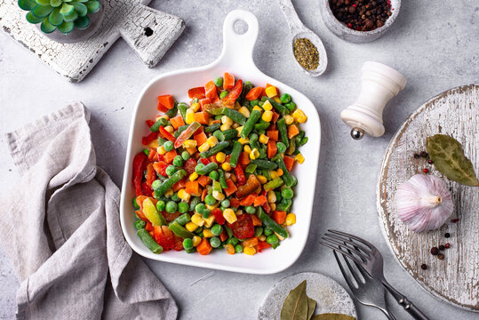 Frozen mix of vegetables on dark background