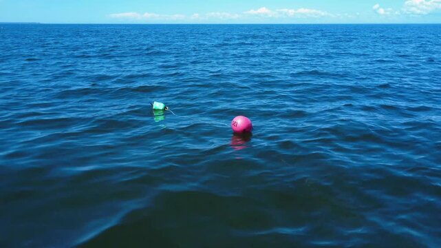 Floating buoys add vibrant color to this scenic St. Lawrence River landscape..