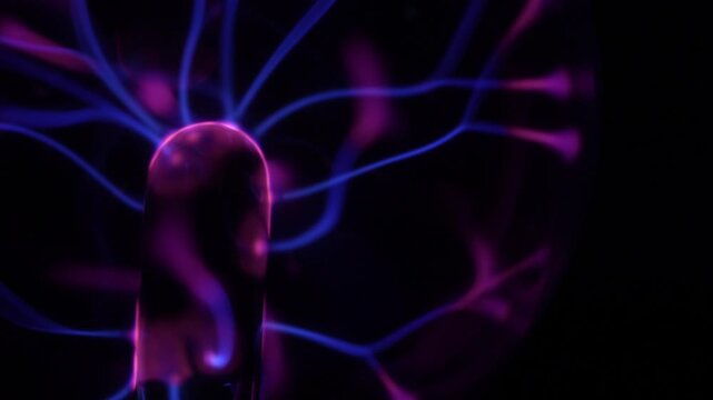 Close-up of the plasma ball coil. The plasma ball creates purple energy beams. The coil is on the left.
