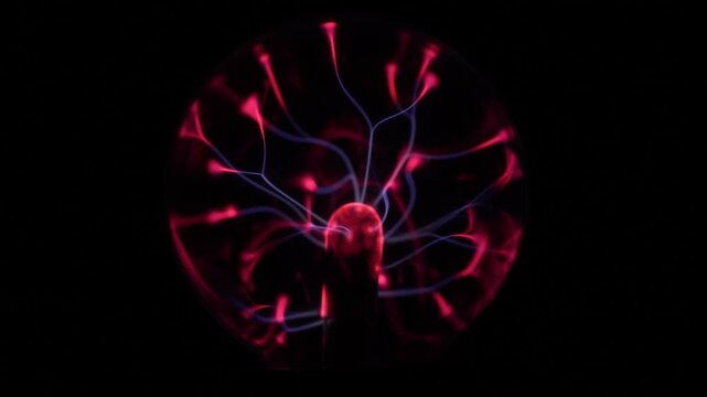 Close-up of the plasma ball in operation. The discharge color is shades of red and purple.