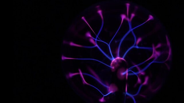 Close-up of the plasma ball in operation. The discharge color is shades of purple.