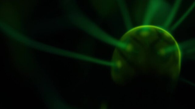 A close-up of the plasma ball coil during operation. The color of the electric rays created by the coil is a shade of green.