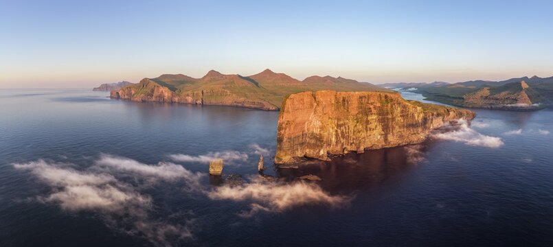 The Risin og Kellingin pinnacles off the Eysturoy cliffs in the evening light, Faroe Islands, Denmark