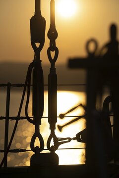 Part of the rigging of a sailing ship, anchoring, steel cables, back light, sunset, silhouette, bokeh effect, Sicily, Italy