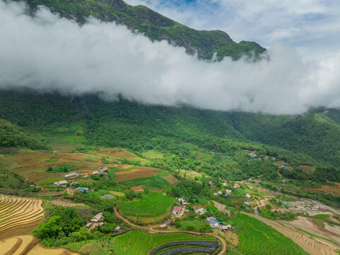 The pouring water season makes the terraced fields of Y Ty, Lao Cai province, Vietnam appear with brown soil blending with the beautiful sky
