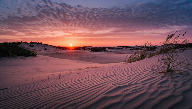 Sunset over Sand Dunes with Wavy Patterns and Cloudy Sky
