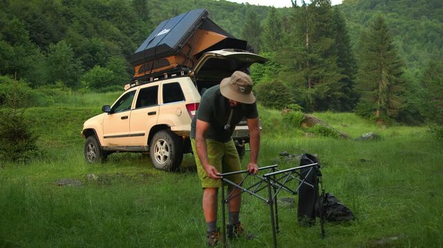 Father and son setting up camp in the forest