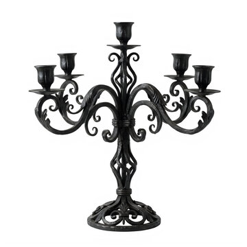 Candelabra made of ornate black wrought iron holds multiple candles to serve as a centerpiece for formal dining.