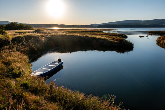 Magical Sunset over the lake with a beautiful reflection on the water. Serene lake in blue hour. Nature landscape