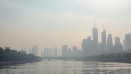 Naklejka premium Foggy Skyline Reflection Over Water in Soft Morning Light