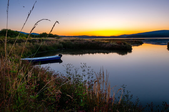 Magical Sunset over the lake with a beautiful reflection on the water. Serene lake in blue hour. Nature landscape