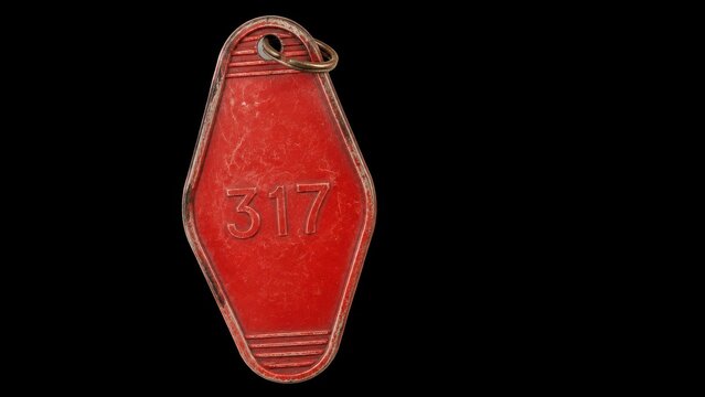Vintage red key tag with number 317 on black background