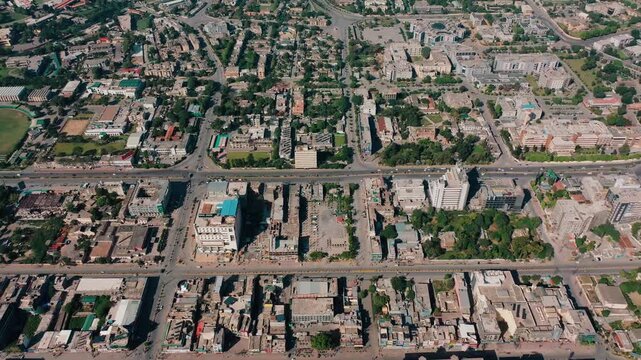 Top Down Drone Footage of Railway Yard Alongside Old Town Rooftops and Narrow Streets in Rawalpindi Pakistan